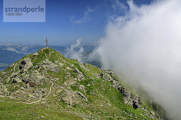 Austria  Tyrol  Summit cross on Gilfert peak with thick cloud in foreground