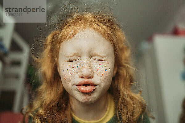 Redhead girl making facial expression at home