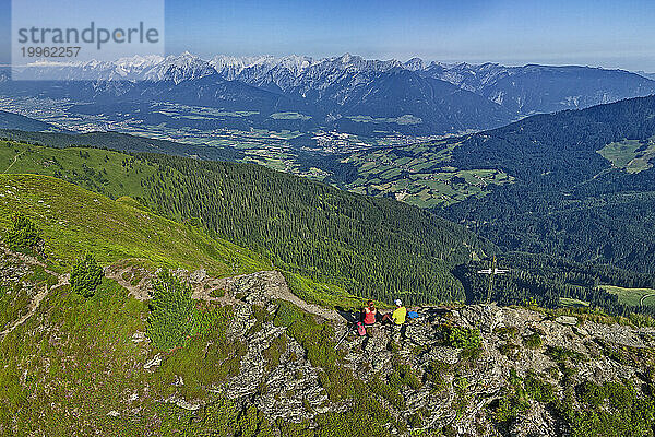 Austria  Tyrol  Aerial view of two hikers admiring view from Gamsstein mountain