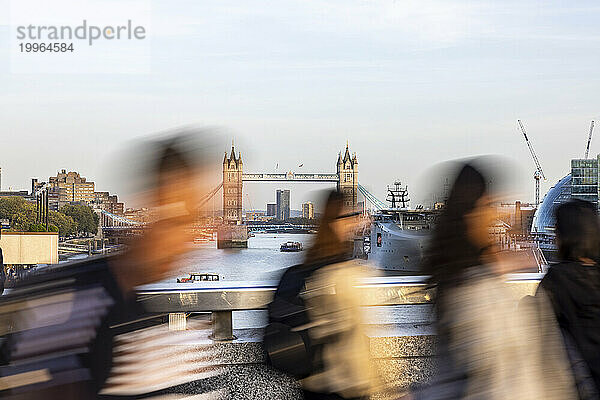 Commuters walking on bridge in London city  UK