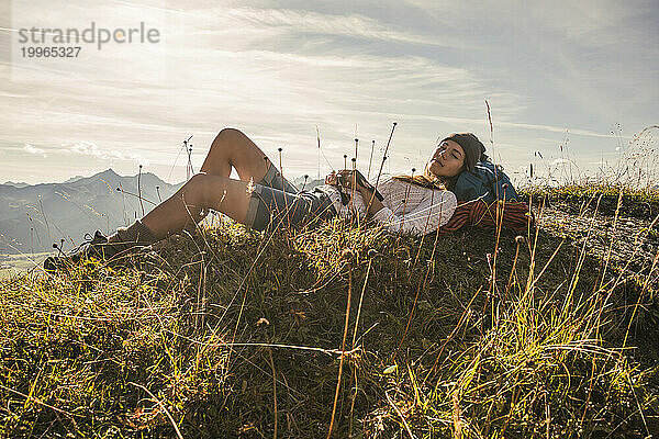Young woman resting on mountain in Tannheimer Tal  Tyrol  Austria