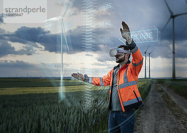 Ingenieur mit VR-Brille und Programmierung durch digitales Windkraftanlagendesign vor Ort