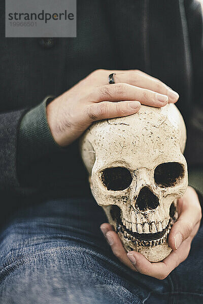 Man holding human skull