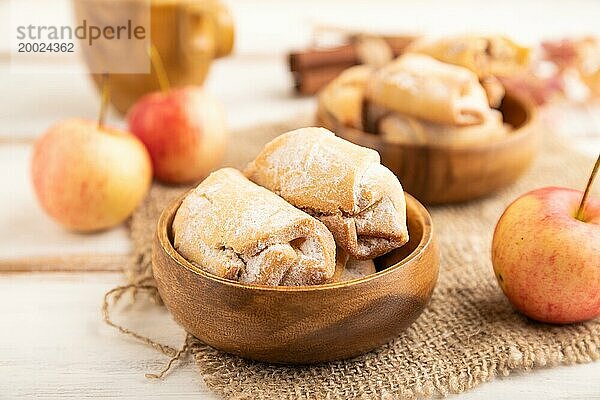 Hausgemachte süße Kekse mit Apfelmarmelade und Tasse Kaffee auf weißem hölzernem Hintergrund und Leinenstoff. Seitenansicht  Nahaufnahme  selektiver Fokus