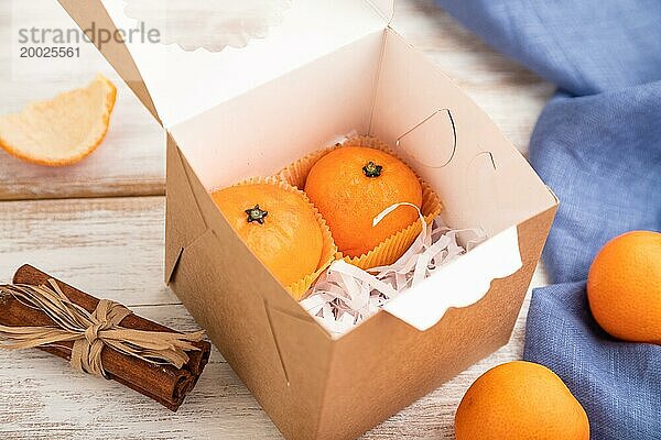 Trüffel Schokoladen Mandarinen Bonbons auf weißem Holzhintergrund und blauem Leinenstoff. Seitenansicht  Nahaufnahme  selektiver Fokus