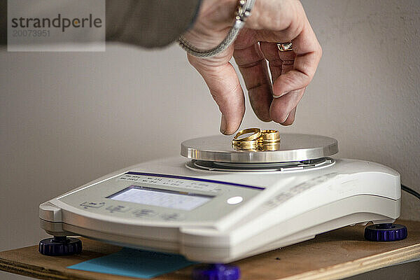 Jewelry maker weighing gold