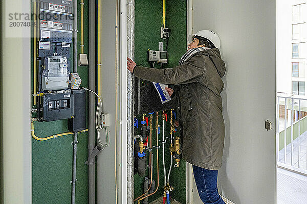 Female Construction manager inspecting electrical installation