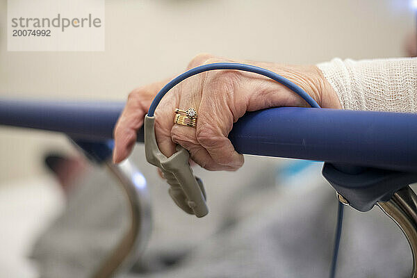 Elderly lady in a hospital bed under observation with healthy issues. Heart monitor