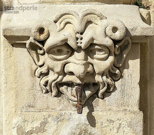 In Stein gemeißeltes Gesicht eines alten Brunnens in Cuenca  Kastilien La Mancha  Spanien: Schlange  die aus dem Mund kommt