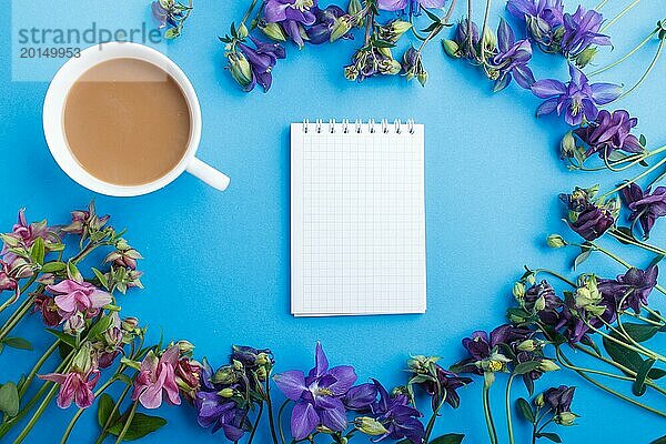 Rosa und lila Akelei Blumen und eine Tasse Kaffee mit Notebook auf pastellblauem Hintergrund. Morninig  Frühling  Mode Zusammensetzung. Flachlage  Draufsicht  Kopierraum