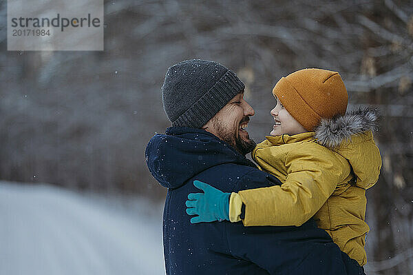 Vater und Sohn haben Spaß im Winterwald