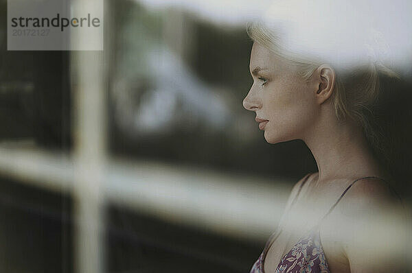 Pensive woman looking out of window