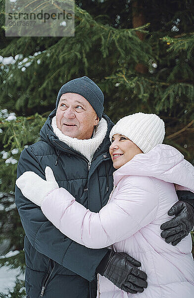 Happy mature couple wearing warm clothes in winter