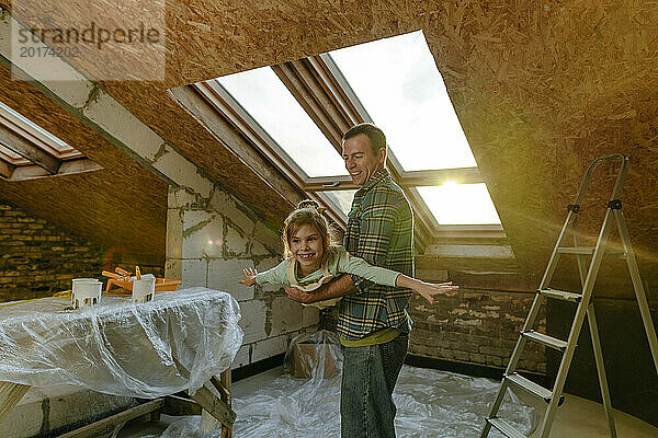 Vater und Tochter vergnügen sich im renovierten Dachboden