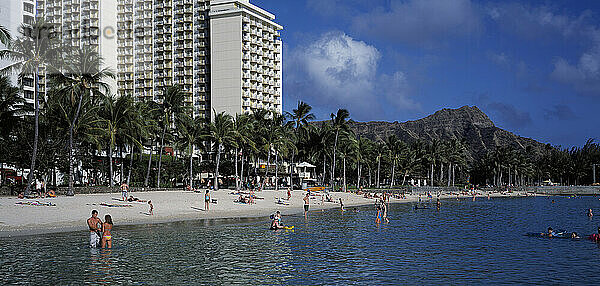 Hawaii. Honolulu. Waikiki Beach mit Menschen und Hotelgebäude.
