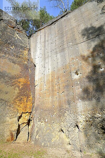 Natural climbing wall made of sandstone in a quarry. Natürliche Kletterwand in Tschechien