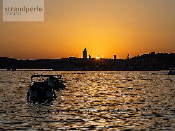 Abendrot bei Sonnenuntergang  Silhouette der Kirchtürme von Rab  Boote ankern in eienr Bucht  Stadt Rab  Insel Rab  Kvarner Bucht  Kroatien  Europa