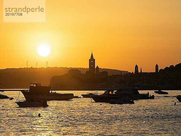 Boote ankern in einer Bucht  Silhouette von einem Kirchturm  Sonnenuntergang über Rab  Stadt Rab  Insel Rab  Kvarner Bucht  Kroatien  Europa