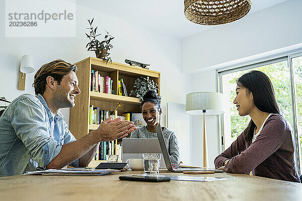 Entrepreneurs having a meeting in living room during daytime