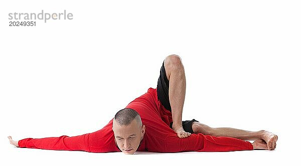 Flexibler Mann mittleren Alters in schwieriger Yoga Pose