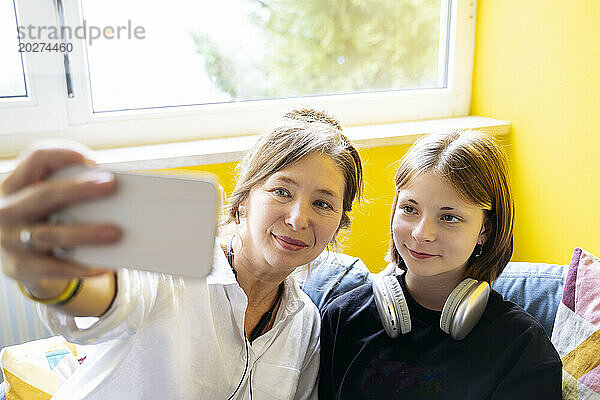 Reife Lehrerin macht Selfie mit Mädchen in der Schule