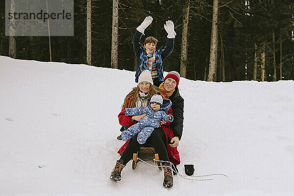 Happy family having fun in winter forest