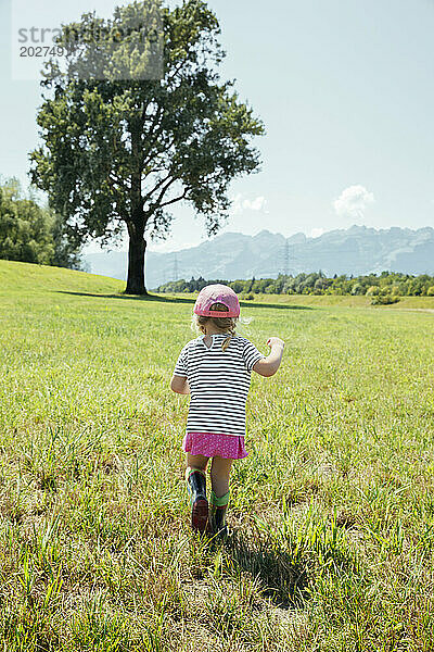 Girl walking on grass in meadow at Vorarlberg  Austria