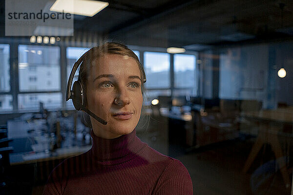 Young customer care representative wearing headset in office