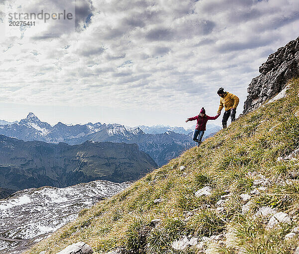 Couple moving down on mountain at Bavarian Alps in Germany