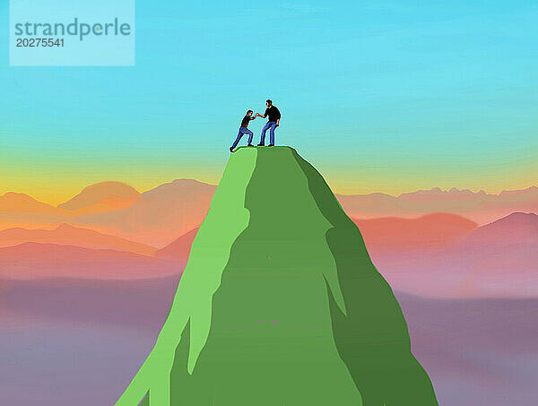 Man helping another man reach mountaintop
