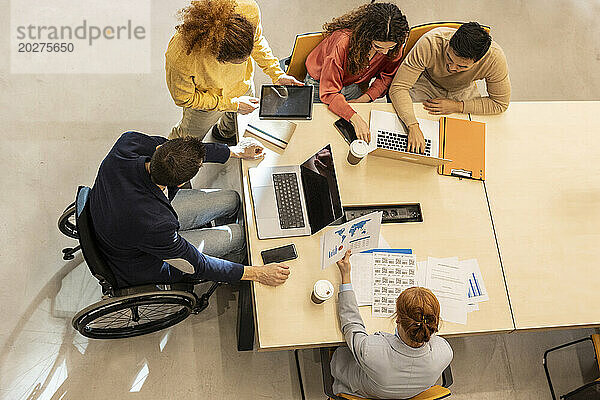 Business colleagues working together at desk in office