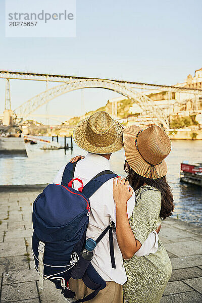 Young couple standing in front of Dom Luis bridge at Porto  Portugal