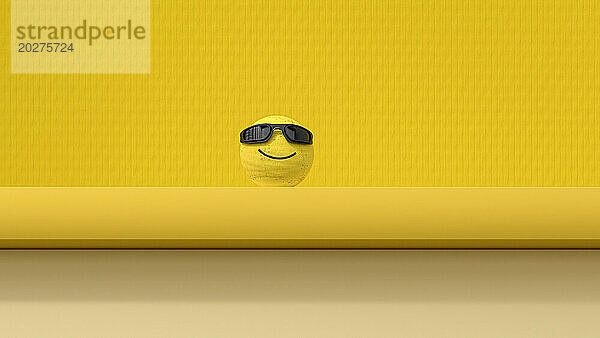 3D-Darstellung einer Smiley-Gesichtskugel vor gelbem Hintergrund
