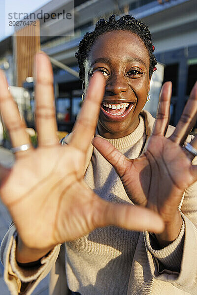Cheerful woman showing stop gesture