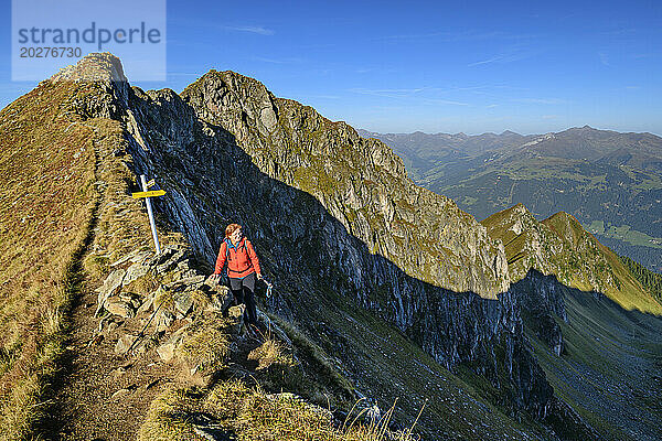 Austria  Tyrol  Female hiker following Aschaffenburger Hohenweg trail in Zillertal Alps