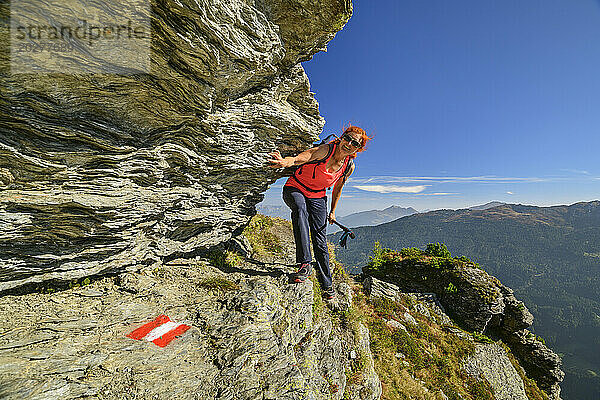 Austria  Tyrol  Female hiker following steep trail towards Rosskopf