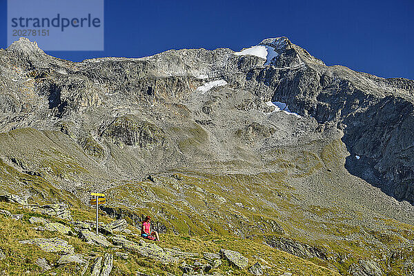 Austria  Tyrol  Female hiker taking break along Aschaffenburger Hohenweg trail in Zillertal Alps