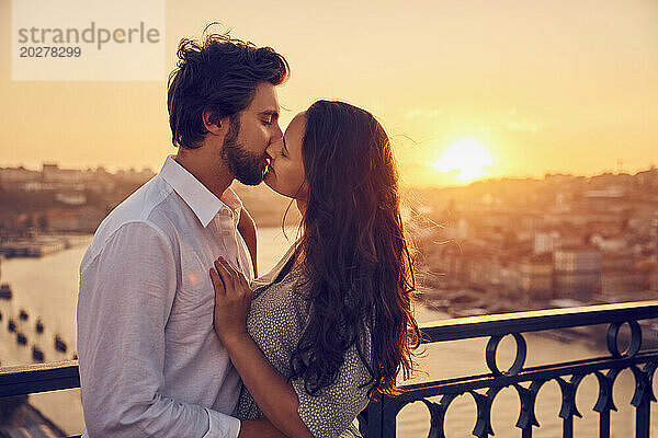 Romantisches junges Paar küsst sich vor dem Fluss Douro in Porto  Portugal