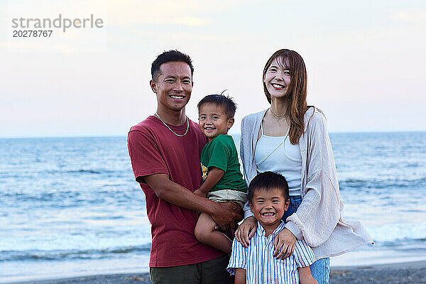 Asiatische Familie am Strand