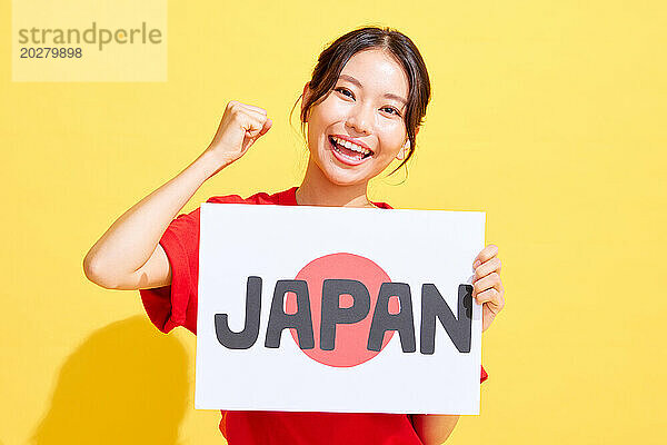 Asiatische Frau hält Japan-Schild