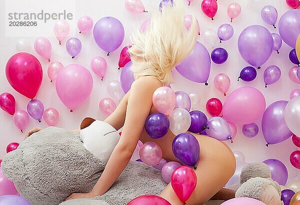 Bild der nackten Blondine posiert mit Luftballons und Teddybär
