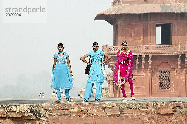 Drei Frauen in traditioneller Kleidung stehen lachend auf einer alten Festungsmauer  Jaipur  Rajasthan  Nordindien  Indien  Asien