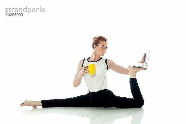 Bild der Frau posiert in unwirklichen Pose mit Laptop  vor weißem Hintergrund