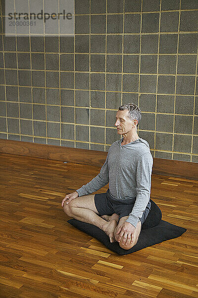 Reifer Mann praktiziert Yoga  einfache Pose