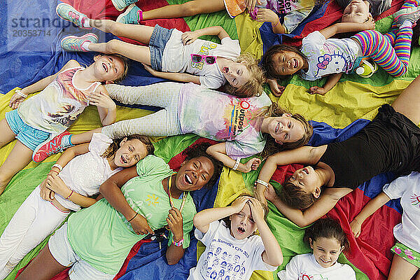 Kinder im Sommercamp in San Diego  Kalifornien  liegen dicht nebeneinander auf dem Boden über einem Zelt.