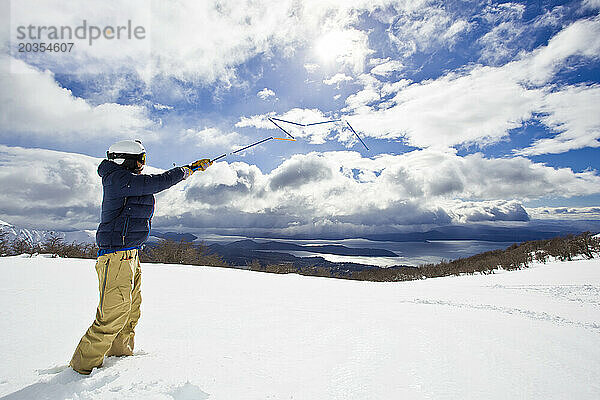 Ein Mann übt mit seiner Lawinensonde in einer verschneiten Landschaft