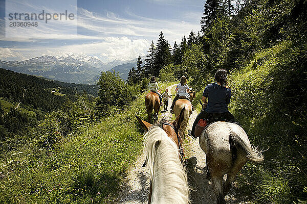 Mädchen reiten in den französischen Alpen.