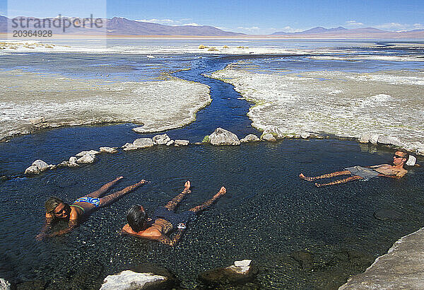 Erwachsene baden in heißen Quellen der Atacama-Wüste in Chile.
