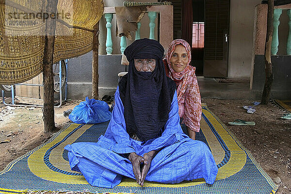 A Muslim Toureg husband and wife sitting on a mat wearing turban and shawl  Mali  West Africa