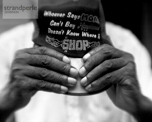 Detail shot of an older African Americans hands holding a hat.